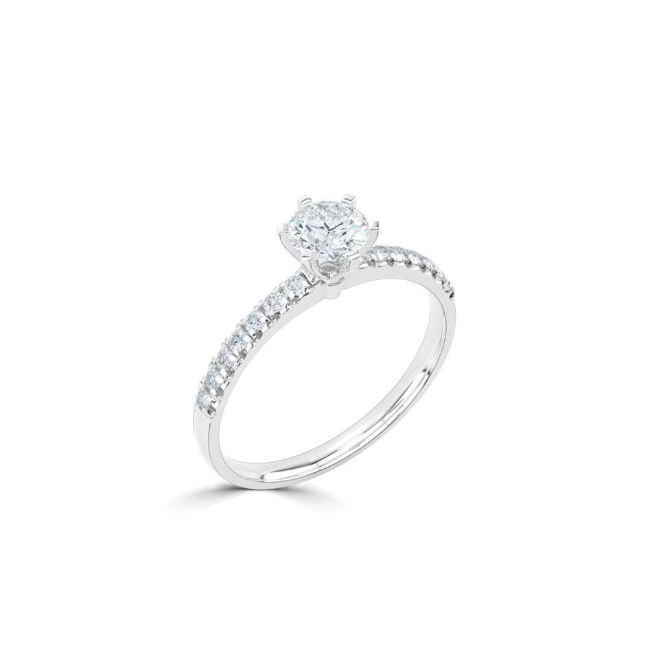 A timeless six-claw solitaire featuring fishtail-set diamond shoulders.